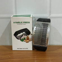 Compact stainless steel garlic crusher