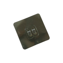 Transparent adhesive wall hook attached to glass surface